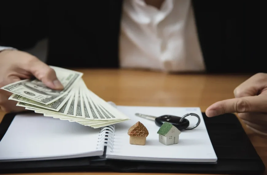 Property settlement concept with cash, house models, and car keys.